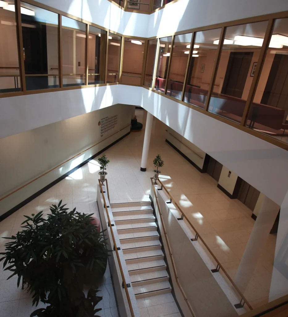 Blick von oben auf Treppenanlage und hellen Kunststeinboden im Atrium